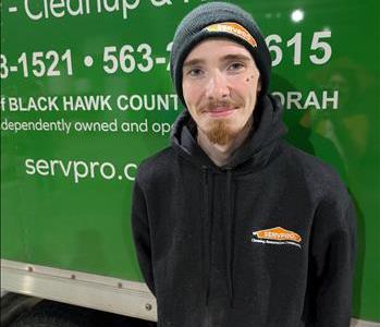 smiling man in front of green truck