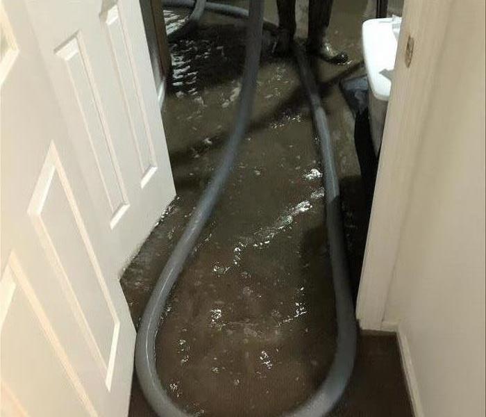 Cement flooring covered by several inches of rushing water.