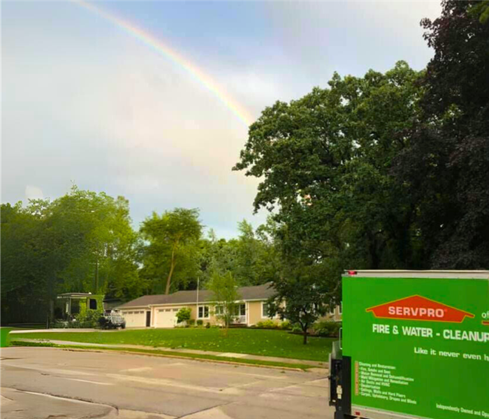 A SERVPRO truck with rainbow in the backround
